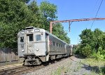 NJT Train # 429 about to cross the Division Avenue Grade Crossing just before making the station stop. Arrow III Cab Car # 1366 is in the lead 